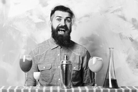 Brutal caucasian hipster with alcoholic cocktails and bar stuffの写真素材
