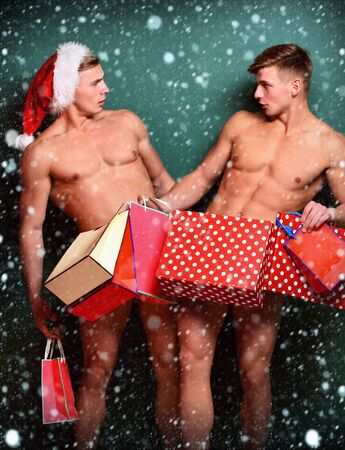handsome macho santa twins with sexy muscular athletic strong bodyの写真素材
