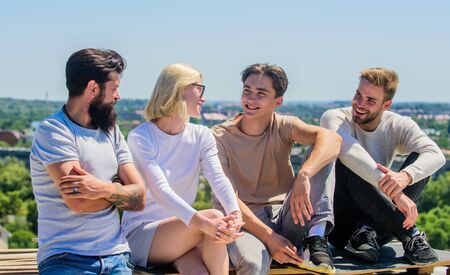Family traditions. diverse young people talking together. happy men and girl relax. group of four people. great fit for day off. best friends. Summer vacation. Group of people in casual wearの写真素材