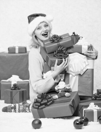 Perfect gift for girlfriend or wife. Opening christmas gift. Santa bring her gift that she always wanted. Girl near christmas tree happy celebrate holiday. Woman excited blonde hold gift box with bowの写真素材