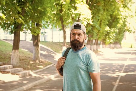 Bearded and brutal. Bearded man on urban background. Serious bearded hipster in casual style on summer outdoor. Caucasian guy wearing mustache and beard on bearded faceの写真素材