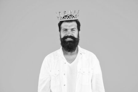 just smile. Love yourself. hipster man king costume party. brutal and handsome prince yellow background. Egoist selfish man. Narcissistic person. Superiority complex. Bearded man wear whiteの写真素材