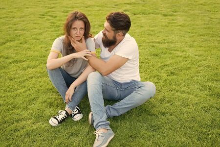 Simple happiness. Couple relations goals. Playful girlfriend and boyfriend dating. Summer vacation. Lovely couple outdoors. Couple spend time in nature. Couple in love relaxing on green lawnの写真素材