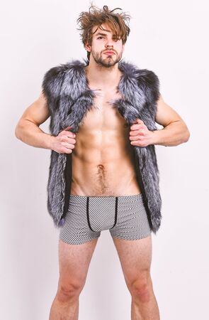 Sexy sleepy rich macho tousled hair fur vest on white background. Guy attractive fashion model...