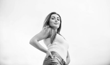 Daily outfit. Developing own style. Forgoing designer labels does not have to mean sacrificing style. Street style. Wearing accessible pieces. Fashion girl. Stylish sexy girl outdoors sky backgroundの写真素材