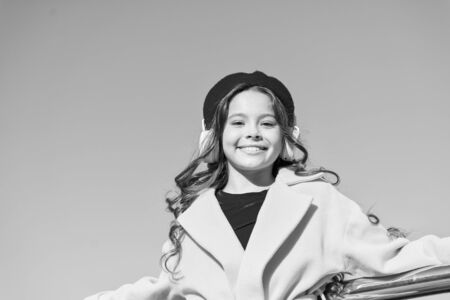 Good vibes. Child smiling face relax outdoors on sunny day. Music in headphones. Modern headphones. Music for long walks. Feel the rhythm. Little girl listening audio book. Adorable kid listen musicの写真素材