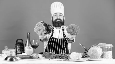 Chef man in hat. Secret taste recipe. Dieting and organic food, vitamin. Vegetarian. Street food. Mature chef with beard. Healthy food cooking. Bearded man cook in kitchen, culinaryの写真素材