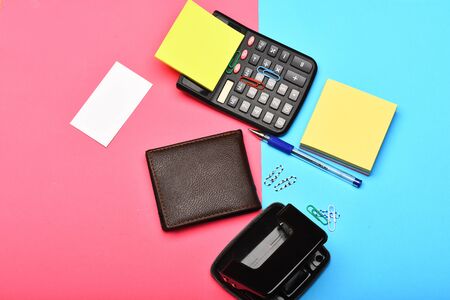 Mans leather wallet and stationery. Business and work concept. Calculator, hole punch, business...