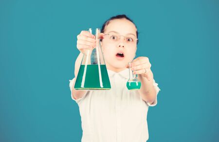 education and knowledge. back to school. child study bilogy lesson. small smart girl with testing flask. science research in lab. Small school girl. Confident at her researchesの写真素材