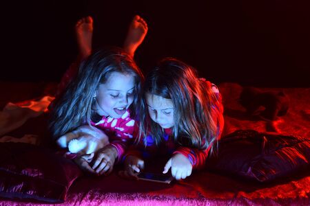 Party and fun concept. Kids in pajamas watch movie