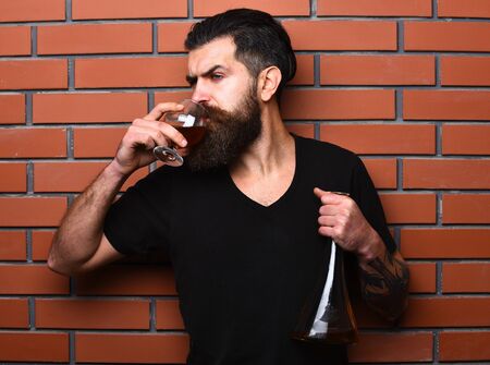 Guy with glass and bulb of cognac.