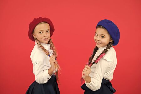 Best friends. Schoolgirls wear formal school uniform. Children beautiful girls long braided hair. Little girls with braids ready for school. School fashion concept. Fancy style. School friendshipの写真素材