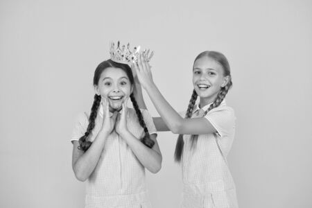 motivation to be the best. small egoist girls imagine they are princess. success reward. happy childhood frienship. retro look of selfish kids. vintage girls in gold crown. Beauty is not enoughの写真素材