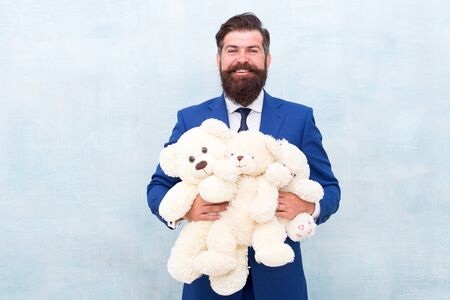 Lets play all day. Happy businessman play with soft toys. Childhood play. Playing games. Toy shop. Gift store. Designed for children or grown-ups. Work hard play harderの写真素材