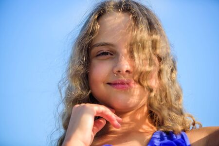 Uv filter sunscreen. Take care. Summer care. Sunscreen concept. Child pleased with warm sunlight looks relaxed blue sky background. Take care skin put sunscreen cosmetics. Girl kid relaxing outdoorsの写真素材