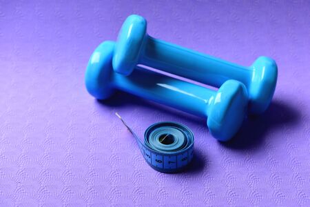 Barbells next to roll of tape. Healthy shape and sport