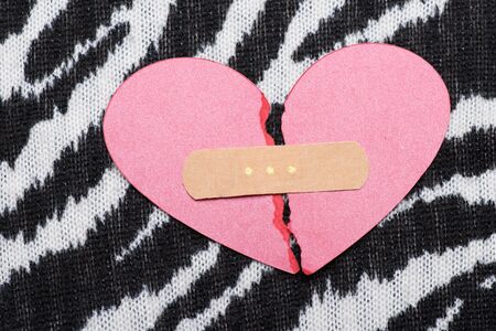 Love and relationship concept. Part of pink broken paper heart