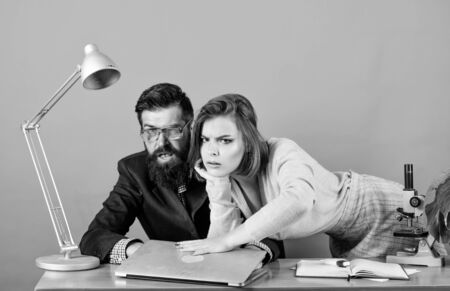 Man of style and status. secretary with boss at workplace. sexy woman and man work in office at laptop. business couple at computer. corporate ethics. businessman and assistant. love affair at worksの写真素材