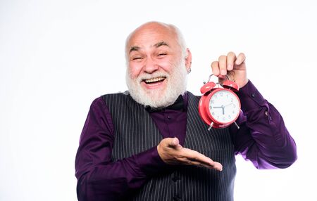 Senior man white beard. Senior timekeeper. Counting time. Time does not spare anyone. Time and age concept. Bearded man clock ticking. Aged man holding alarm clock. Lifetime ageing and getting olderの写真素材