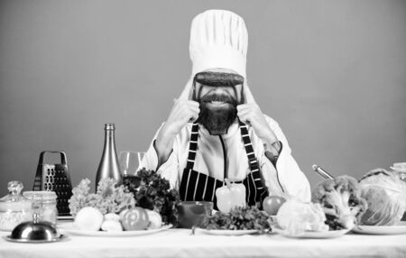 Healthy food. Dieting and organic food, vitamin. Chef man in hat. Secret taste recipe. Bearded man cook in kitchen, culinary. Healthy food cooking. Vegetarian. Mature chef with beard.の写真素材