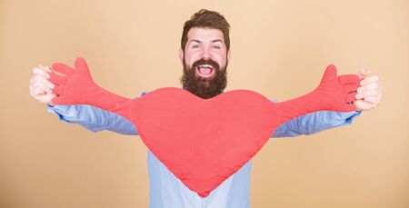 Celebrate valentines day. Guy with beard and mustache in love romantic mood. Feeling love. Dating and relations concept. Happy in love. Make him feel loved every day. Man bearded hipster with heartの写真素材