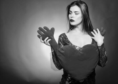 Romantic greeting. Be my valentine. Love and romance. Valentines day sales. Sensual girl with decorative heart. Sexy woman in glamour dress. Valentines day party. I love you. Romantic moodの写真素材