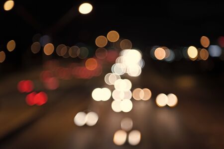 Night city lights. Illumination and lighting. White and red blurred lamps. Watching transport moving...