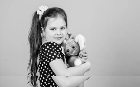 Dreaming of pet. small girl with soft bear toy. child psychology little girl playing game in playroom. happy childhood. Birthday. playground in kindergarten. toy shop. childrens day. Best friendの写真素材