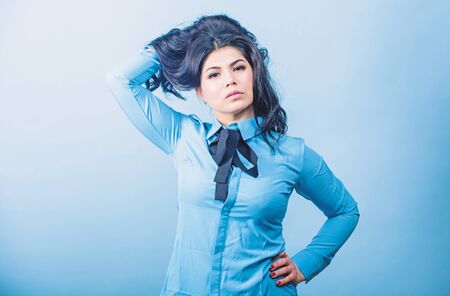 Hairdresser tips. Professional care dyed hair. Encouraging shine and manageability. Brunette hair care. Maximum shine for beautiful hair. Woman pretty brunette girl makeup face. Curly hairstyleの写真素材