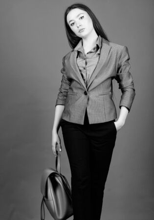 stylish woman in jacket with leather backpack. girl student in formal clothes. student life. Smart beauty. Nerd. business. Shool girl with knapsack. female bag fashion. Ready to studyの写真素材