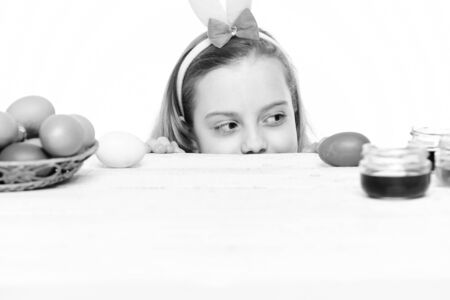 small happy baby girl with easter eggs isolated on whiteの写真素材