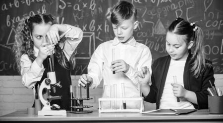 childrens day. students doing biology experiments with microscope. Little kids learning chemistry in school lab. Chemistry. Back to school. Little children at school lesson. New ideas for medicineの写真素材