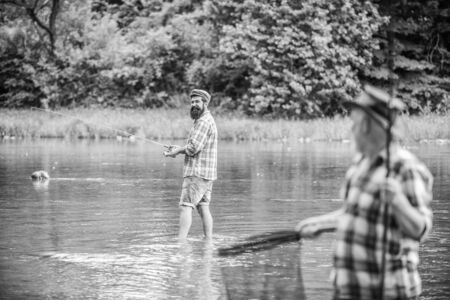 Son and father fishing in the lake.