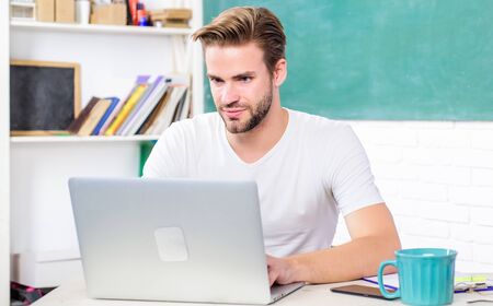 library online. college life. school teacher use laptop and smartphone. student man in classroom...
