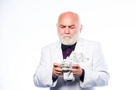 Wealth and rich. business success. Richness. successful businessman. rich mature man has lots of money. retirement. Happy lottery winner. mature bearded man with dollar banknotesの写真素材