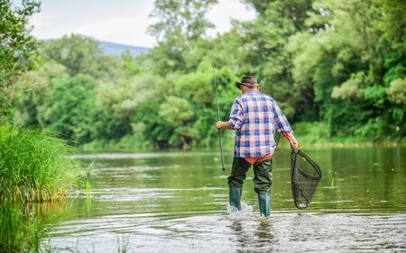 Calling Fly-Fishing a hobby. fisherman with fishing rod. retired bearded fisher. Trout bait. hobby...