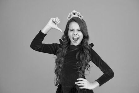 little princess of prom. queen of beauty. it is my award. dreaming to be elegant lady. best kid fashion. airs and graces. masquerade. childhood happiness. happy girl long curly hair in crownの写真素材