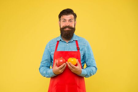 organic food diet. health benefits of tomato. dietary source of vitamins and minerals. brutal cook in apron. vegetable eating tips. bearded man chef with tomato. healthy food cookingの写真素材