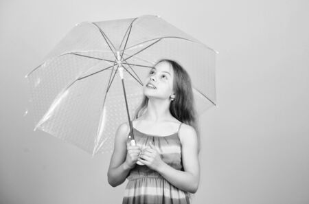 I would stay here forever. autumn fashion. rainy weather. Fall mood. carefree childhood. small girl with umbrella. autumn weather forecast. child with trabsparent parasolの写真素材