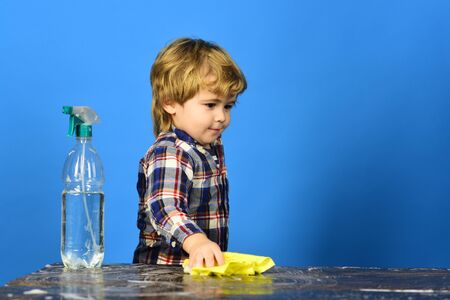 Child with concentrated face, looking at table.の写真素材