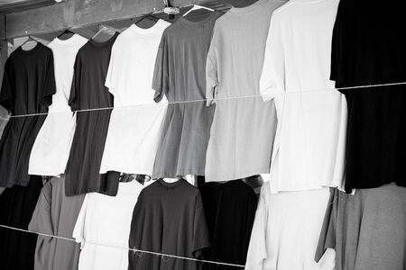 Tshirts hang in local shop or market in castries, st.lucia. Colorful clothes on sale. Sale, shopping and purchase. Black Friday and cyber monday concept.の写真素材