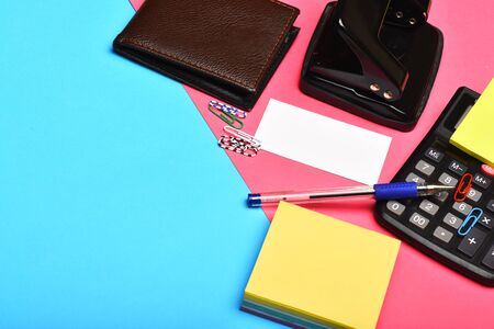 Business and work concept. Mans leather wallet and stationery, copy space Calculator, hole punch,...