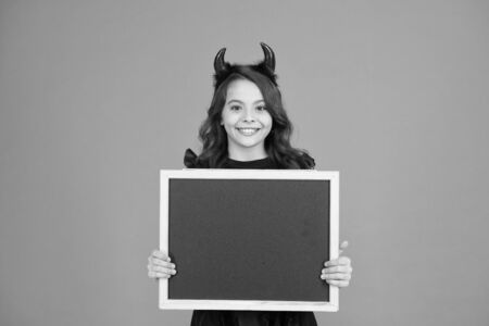 Promoting event. Boo to you from our crew. Little girl cute horns Halloween advertisement. Child imp...