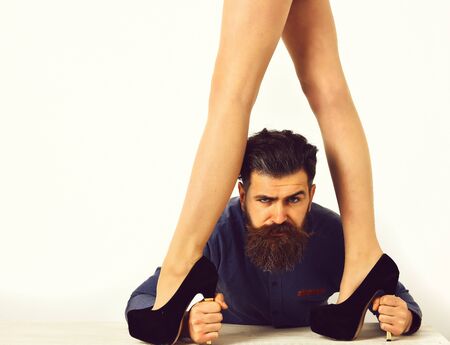 bearded man with sexy female legs has serious faceの写真素材