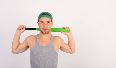 Guy in grey tank top holds bright green bat