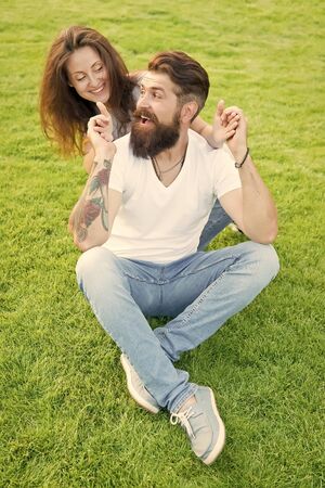 Soulmates closest people. Simple happiness. Couple in love relaxing on green lawn. Playful girlfriend and boyfriend dating. Couple relations goals. Couple spend time in nature. Lovely couple outdoorsの写真素材