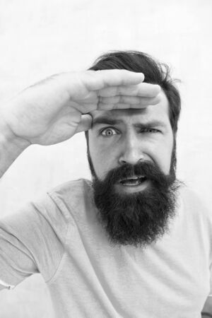Suspicious look. Man bearded hipster stylish beard grey background. Perceptions of male beauty. Stylish beard and mustache care. Strict face. Beard fashion barber. Handsome guy. Masculinity conceptの写真素材