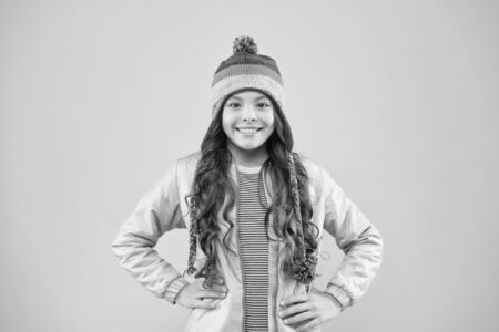 Good time. small girl winter hat. warm clothes for cold season. cheerful child pink background. kid fashion and shopping. trendy girl smiling. ready for winter activity. autumn style. happy childhoodの写真素材