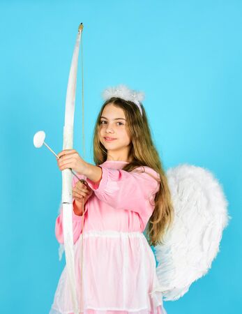 Just happy. happy valentines day. celebrate love. valentine sale and discount. child in angel costume. small angel. girl cupid hold bow and arrow. cupids arrow hit right in heart. love and romanceの写真素材