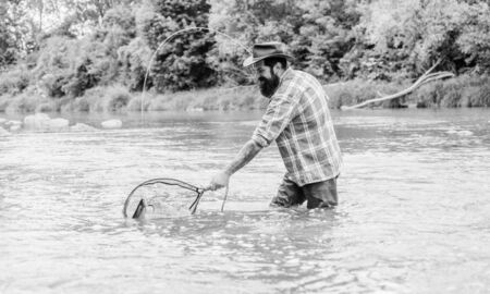 Hooked Up Sportfishing. mature man fly fishing. man catching fish. summer weekend. Big game fishing....